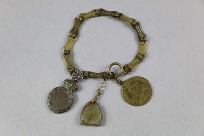 une photo d'un bracelet orné de pièces et de breloques