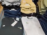 a lot of shirts on a table in a store