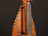 un vieil instrument en bois surmonté d'un couteau, posé sur une table en bois