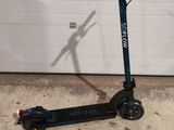 an electric scooter parked in front of a garage door