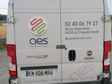 a white van that is parked on the side of the road