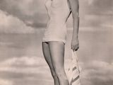 black and white photo of a woman in a bathing suit posing for a picture