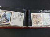 two envelopes with stamps on them sitting on a table