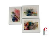 three watercolor paintings of a city and a river in a white frame