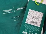 a close up of a green jacket with a tag attached to it