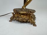 a gold statue of a bird on a table