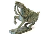 statue of a horse with a rider on it ' s back on a white background