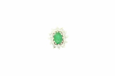 a close up of a green and white diamond ring