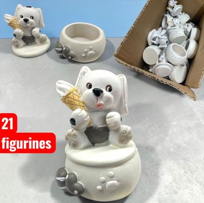 a white bear figurine sitting on a table next to a box of cupcakes