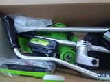 a box with a green and black lawn mower in it
