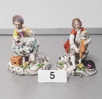 two figurines that are sitting next to each other