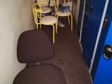 two yellow chairs and a blue door in a small room