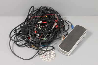 a pile of wires and a pedal sitting on a table