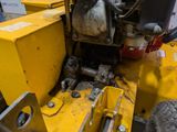 a yellow machine that is sitting on the ground