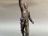 bronze statue of a man holding a bird in his hand