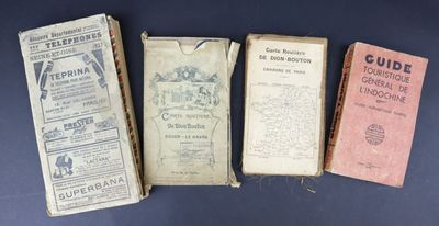 several old books are lined up on a blue surface