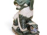 a statue of a dog that is sitting on top of a box