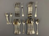 a lot of silver spoons and forks on the table