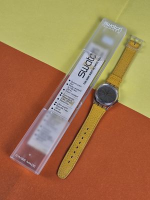 an image of a watch sitting on top of a yellow and orange surface