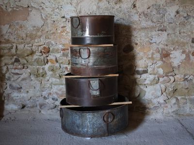 a stack of three old suitcases stacked on top of each other