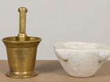 a mortar and a bowl sitting on a table