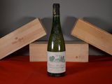 a bottle of wine sitting on a table next to two wooden boxes