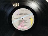 a black record with a label on it on a table