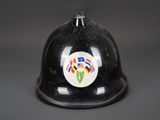 an old fireman ' s helmet with a sticker on it