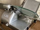 an image of a meat slicer sitting on a kitchen counter