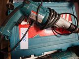 a corded drill sitting on top of a blue box