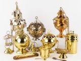 many different types of brass objects on a white surface