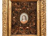 an old picture of a woman in a gold frame on a white background