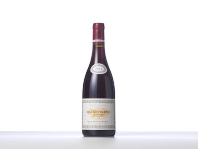 a bottle of red wine sitting on top of a table