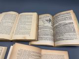 several open books sitting on top of a table next to each other
