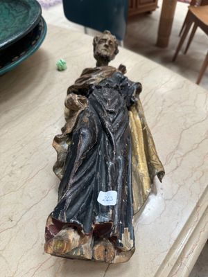a statue of a woman sitting on top of a table