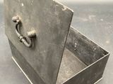 a small metal box with a handle on it