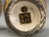 pair of asian vases with asian writing on them sitting on a table