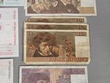 several different bank notes are laid out on a table