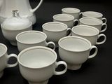 a lot of cups and a pitcher on the table