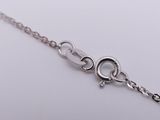 silver plated chain bracelet with a heart charm on a white background