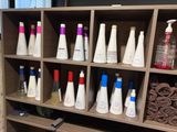many bottles of hair products on a shelf in a bathroom