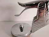 a metal bird that is sitting on top of a table