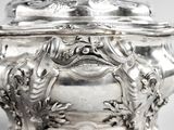 a large silver bowl with a lid on a table