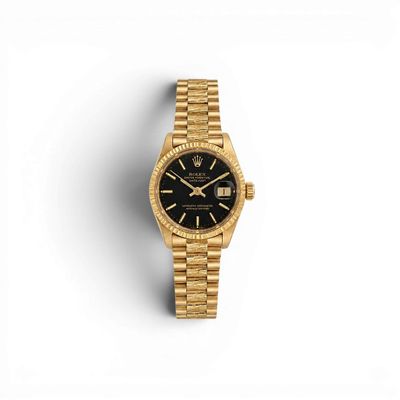 a gold rolex watch with a black dial