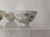 three bowls sitting on a glass shelf in a room
