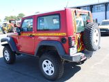 a red jeep that is parked in a parking lot