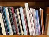 a book shelf with many books on it in a room