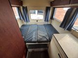 a small bed in the corner of a small room