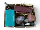 a cardboard box filled with assorted items on a white surface
