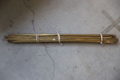 a close up of a bunch of metal rods on a concrete floor